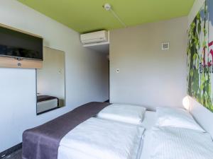 Postel nebo postele na pokoji v ubytování B&B Hotel Ingolstadt-Ost