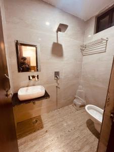 ein Bad mit einem Waschbecken und einem WC in der Unterkunft Divine Ganga by MJ Hospitality in Haridwar