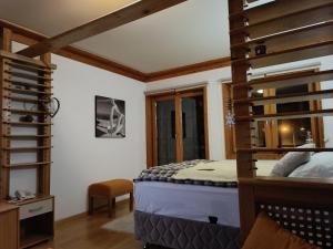 a bedroom with a bunk bed and a ladder at Vučko Apartment 218 in Jahorina
