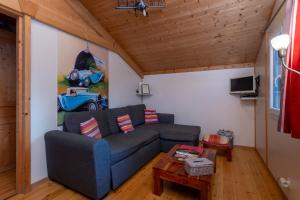 a living room with a couch and a painting on the wall at Les chats perchés 400m plage D in Labenne