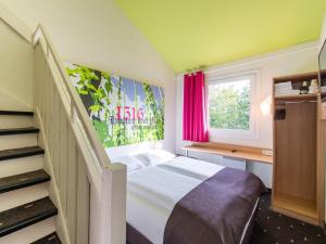 Postel nebo postele na pokoji v ubytování B&B Hotel Ingolstadt-Ost