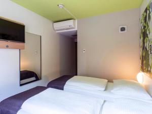 Postel nebo postele na pokoji v ubytování B&B Hotel Ingolstadt-Ost