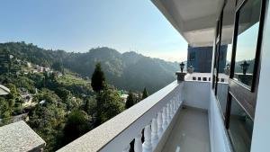 uma varanda com vista para uma montanha em Darjeeling Hillside Inn em Darjeeling