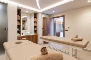 a wellness room with two beds and a mirror at Bali Star Resort Hotel in Balíon