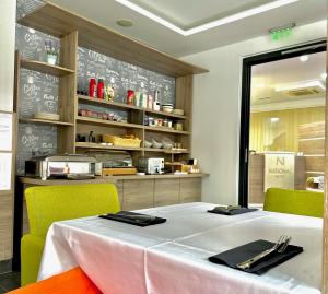 a dining room with a table and green chairs at Hotel National in Zagreb