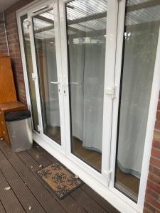 a screened in porch with sliding glass doors at Seaside resort in Felixstowe