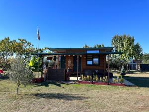 a small cabin with a flag on top of it at Avra Wooden House in Drama