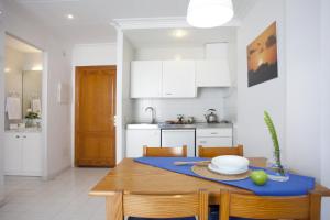 a kitchen with a table with a blue table cloth on it at Apartamento Estándar 1 in Colonia Sant Jordi