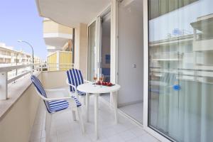 a balcony with a white table and two chairs at Apartamento Estándar 1 in Colonia Sant Jordi