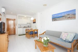 a living room with a couch and a table at Apartamento Estándar 1 in Colonia Sant Jordi