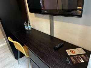 a table with a television and a remote control on it at Albergo Roma in Valdagno