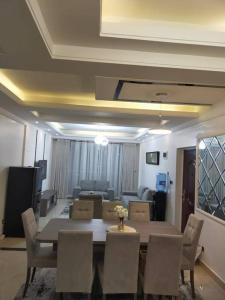 a dining room with a table and chairs at 2 Bedroom in Kilimani Ngong Rd in Nairobi