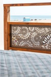 a bed with a view of the ocean from a window at Le ciel, le soleil et la mer in Narbonne