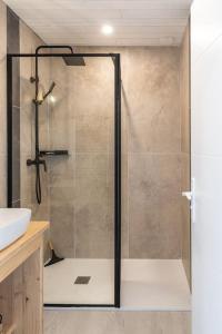 a shower with a glass door in a bathroom at Le ciel, le soleil et la mer in Narbonne +7 photos