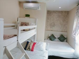 a small room with two bunk beds and a bed at Sekinchan PaddyView Homestay in Sekinchan