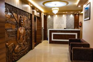 a lobby with a wall mural of a woman at Hotel Samriddhi Pvt Ltd in Bhairāhawā