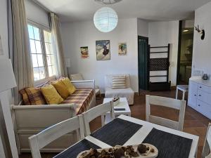 a living room with a couch and a table at IMEDA Apartamento Salvia Dos Dormitorios in Sierra Nevada