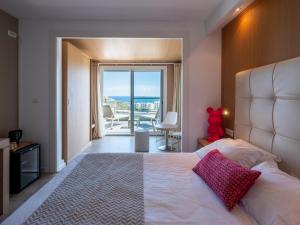 a bedroom with a bed and a view of the ocean at Hotel Revellata & Spa in Calvi