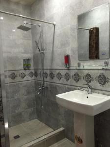 a bathroom with a sink and a shower at Hello Dushanbe Hostel in Dushanbe