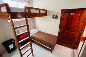 a bedroom with two bunk beds and a ladder at Casa #344 - Habitación 2 - Twin & Bunk Bed - NO AC in Puerto Ayora