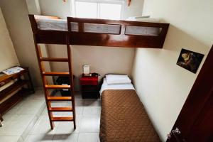 a small room with two bunk beds and a ladder at Casa #344 - Habitación 2 - Twin & Bunk Bed - NO AC in Puerto Ayora +5 photos