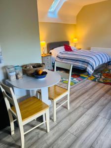 a small room with a table and a bed at Pentre Cerrig Country House in Llanferres