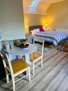 een kleine kamer met een tafel en een bed bij Pentre Cerrig Country House in Llanferres