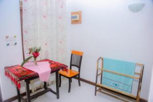 a dining room with a table and two chairs at Seyoo Villa in Ahangama