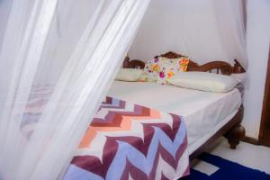 a bedroom with a bed with a canopy at Seyoo Villa in Ahangama