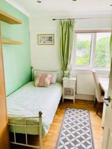 a small bedroom with a bed and a window at Single chic room with beautiful landscape and garden view in Sydenham