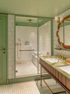a bathroom with a shower and a tub and a sink at La Fantaisie in Paris