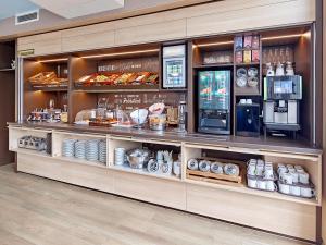 a bakery counter with food items on display at B&B Hotel Köln-Airport in Cologne