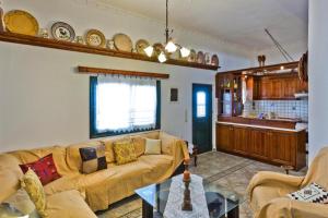 a living room with a couch and a table at Villa Ntora in Afiartis