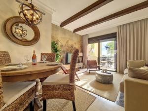 a living room with a table and chairs and a couch at Roda Golf Bali Apartment - 2610 in Roda