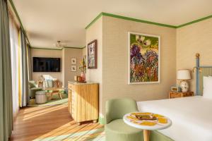a hotel room with a bed and a living room at La Fantaisie in Paris