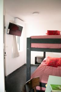 a bedroom with a bunk bed and a desk with a chair at Habitaciones Temporarias CABA in Buenos Aires