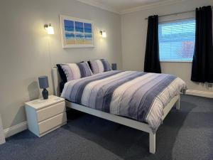 a bedroom with a bed and a window at Rockmount Court in Bournemouth