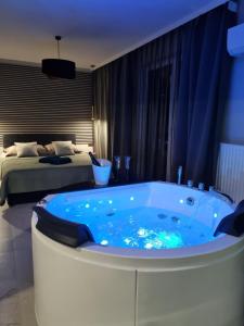 a bath tub in a room with a bed at Apartament Jacuzzi in Kraków