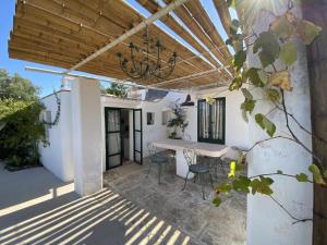 a patio with a table and chairs and a ceiling at Trulli di Ivana in Ostuni