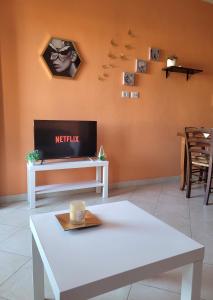 a living room with a white table and a fireplace at ButterflyHouse in Monserrato