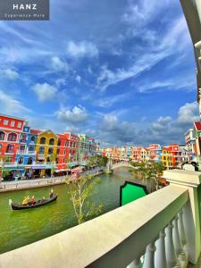 a boat on a river in a city with colorful buildings at HANZ VeniceRiver Power MIA Grand World in Phu Quoc