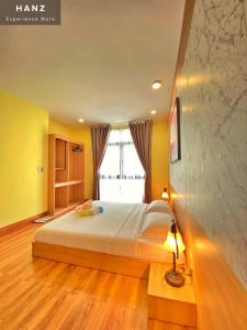 a bedroom with a bed and a large window at HANZ VeniceRiver Power MIA Grand World in Phu Quoc