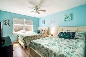 1 dormitorio con 2 camas y ventilador de techo en Large 2BR Across From Beach & 5 Min From Hangout en Gulf Shores