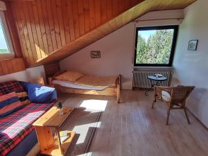 a attic room with a bed and a couch at Ferienwohnung am Sonnenberg in Hammelbach