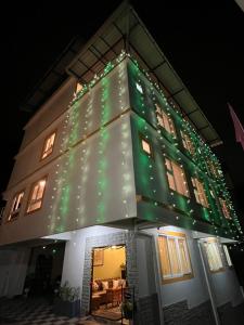 a house with christmas lights on the side of it at Little Sikkim Inn in Gangtok
