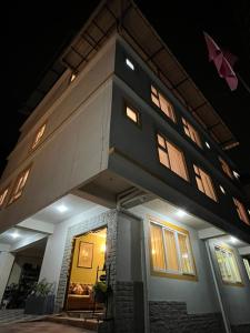 a large house with a gambrel roof at night at Little Sikkim Inn in Gangtok