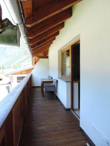 a balcony of a house with a table and a window at Haus Renate in Kaunertal