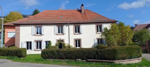a white house with a red roof at Gite de La Falle in Plaine