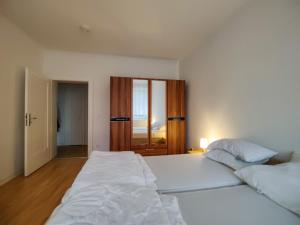 a large white bedroom with two beds in it at Ferienwohnung Jänschwalde in Jänschwalde Ost