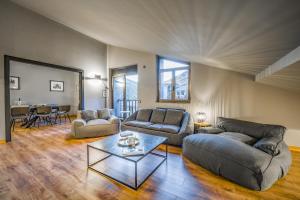a living room with two couches and a table at KOKONO Vacation Rental Apartment El Tarter, Andorra in El Tarter